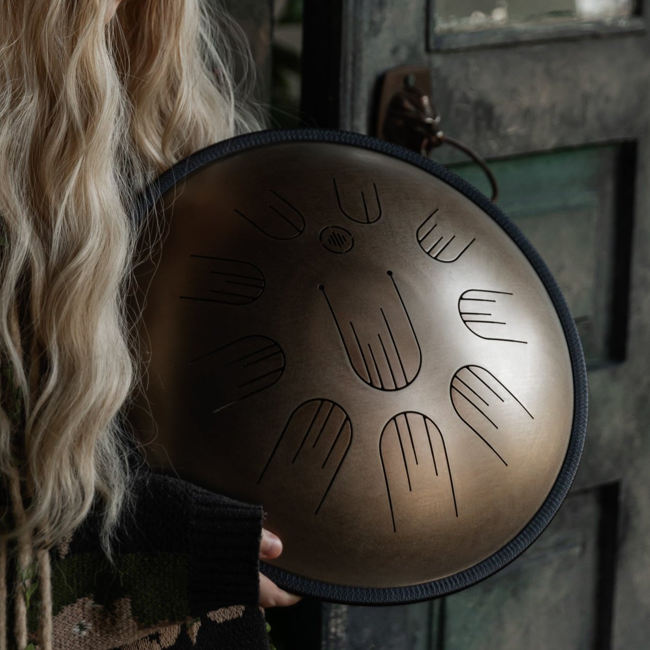 Person playing the Novadrum 38 steel tongue drum (also known as handpan)