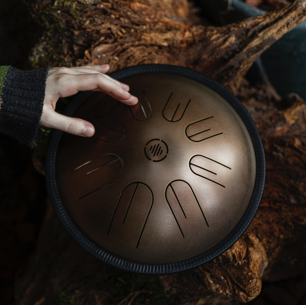 Person playing the Novadrum 28 steel tongue drum (also known as a steel tongue drum or tank drum)