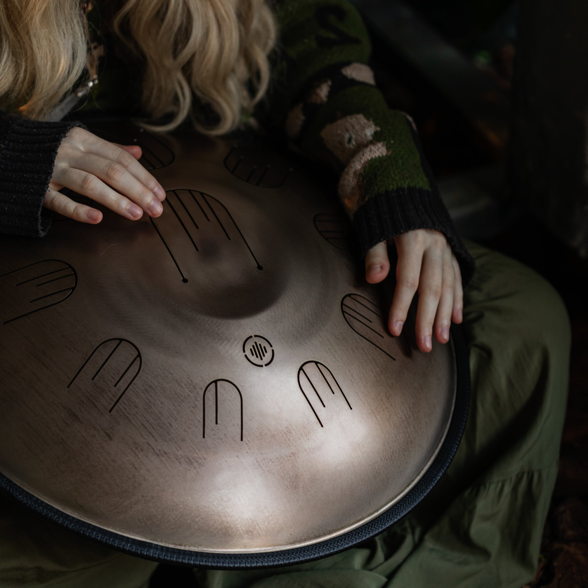 Person playing the Novadrum48 big steel tongue drum (also known as handpan)