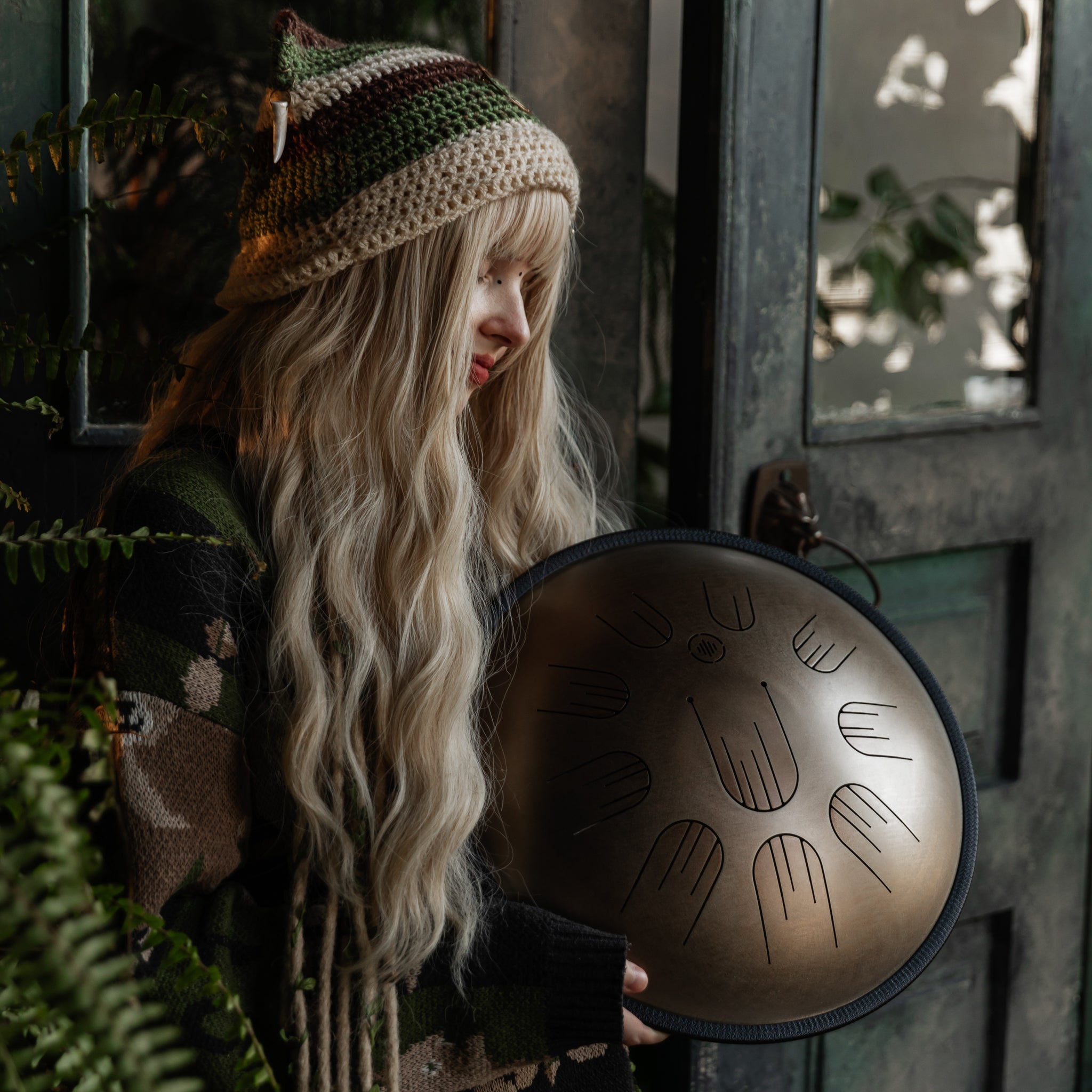 Person playing the Novadrum 38 steel tongue drum (also known as handpan)