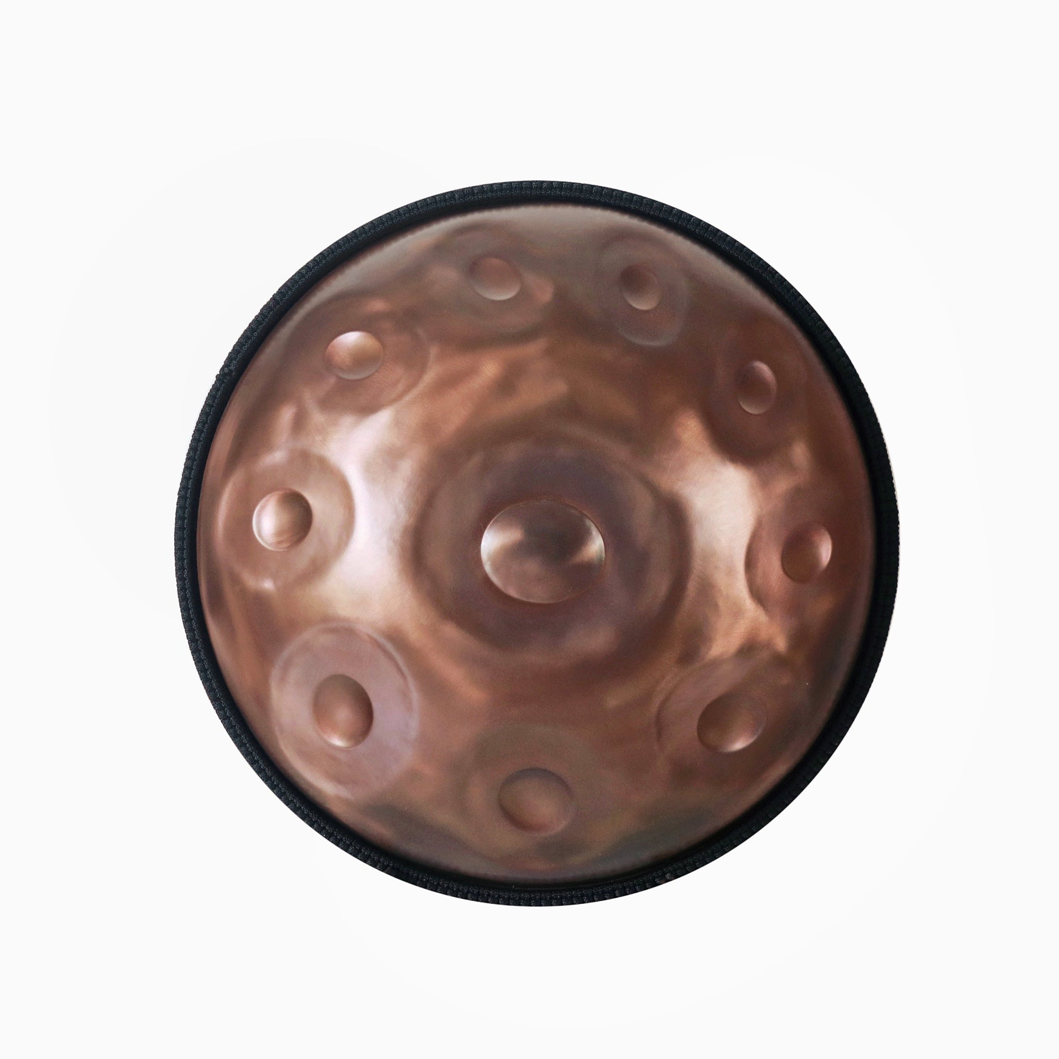 Top view of a handcrafted Novadrum handpan with 9 tone fields, featuring a brushed bronze finish and central ding, made for meditative soundscapes and musical expression.