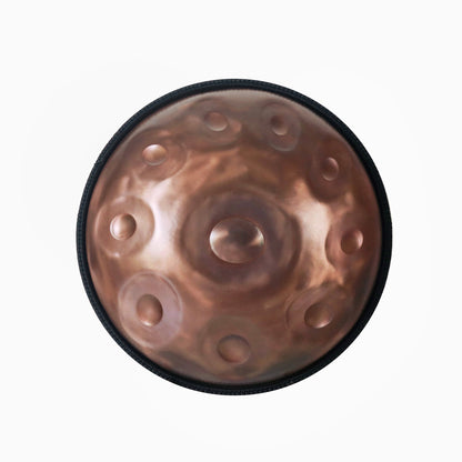 Top view of a handcrafted Novadrum handpan with 9 tone fields, featuring a brushed bronze finish and central ding, made for meditative soundscapes and musical expression.