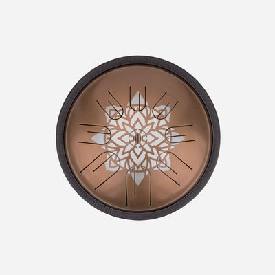 Front view of Novadrum 28 steel tongue drum in stainless steel, with precision-cut tongues arranged symmetrically around a central logo with Mandala engraving.