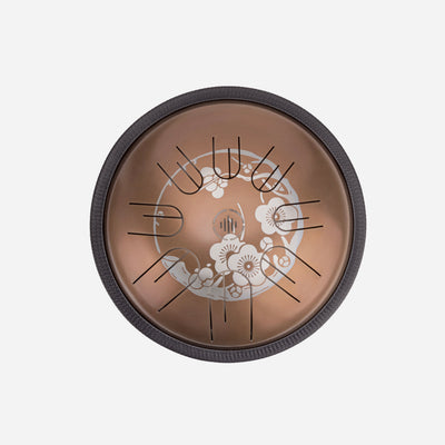 Front view of Novadrum 28 steel tongue drum in stainless steel, with precision-cut tongues arranged symmetrically around a central logo with Sakura engraving.