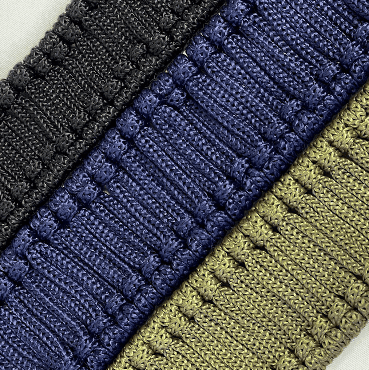 Three rope braids in black, blue, and green, designed for use as an decorative element with a steel tongue drum.