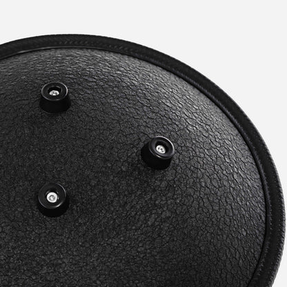 Close-up back view of the Novadrum 28 steel tongue drum in black textured finish, featuring three rubber feet and a black protective rim