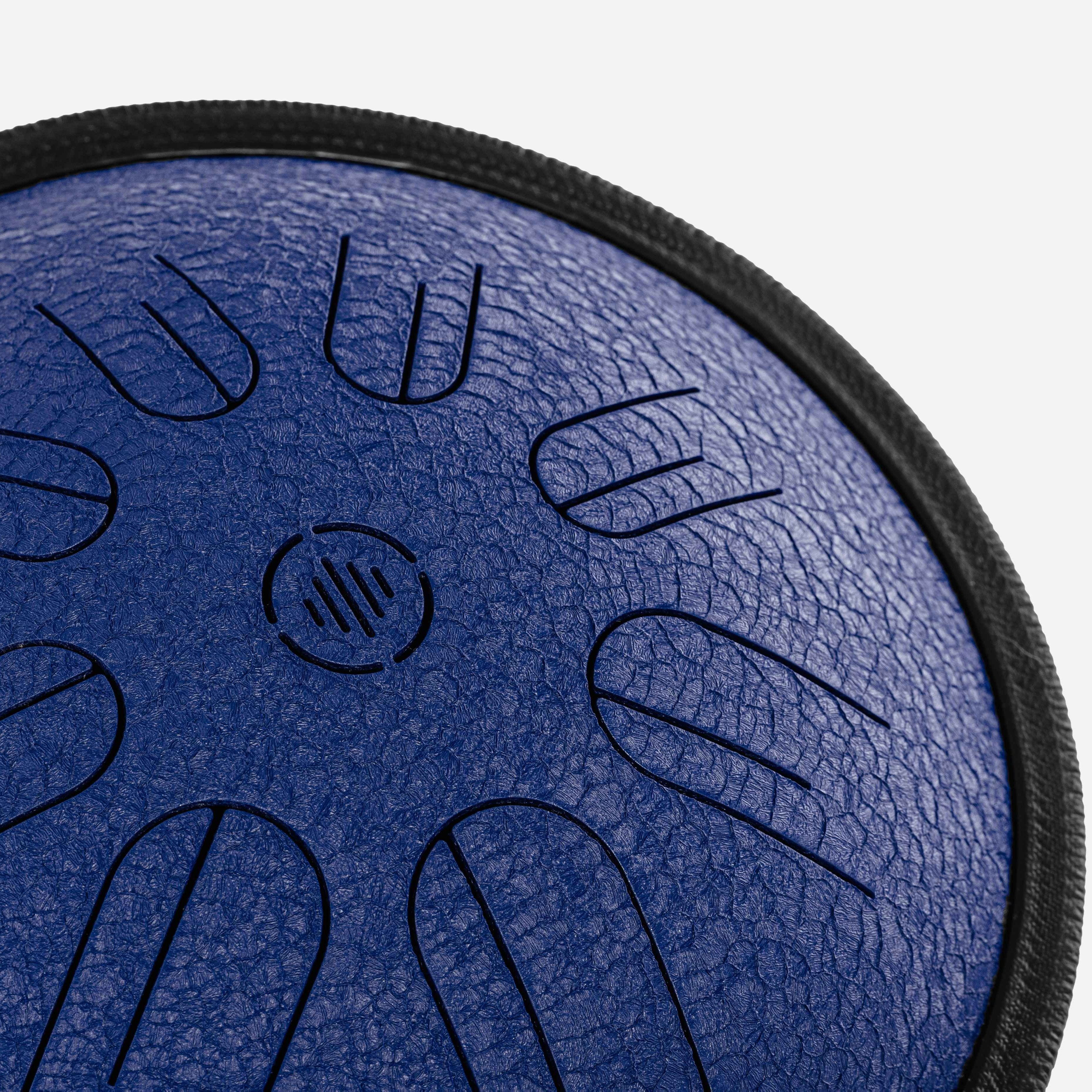 Close-up front view of Novadrum 28 steel tongue drum in blue textured finish, highlighting precision-cut tongues and centered logo.