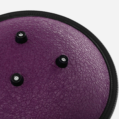 Close-up back view of the Novadrum 28 steel tongue drum in purple textured finish, featuring three rubber feet and a black protective rim