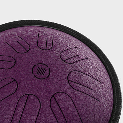 Close-up front view of Novadrum 28 steel tongue drum in purple textured finish, highlighting precision-cut tongues and centered logo.