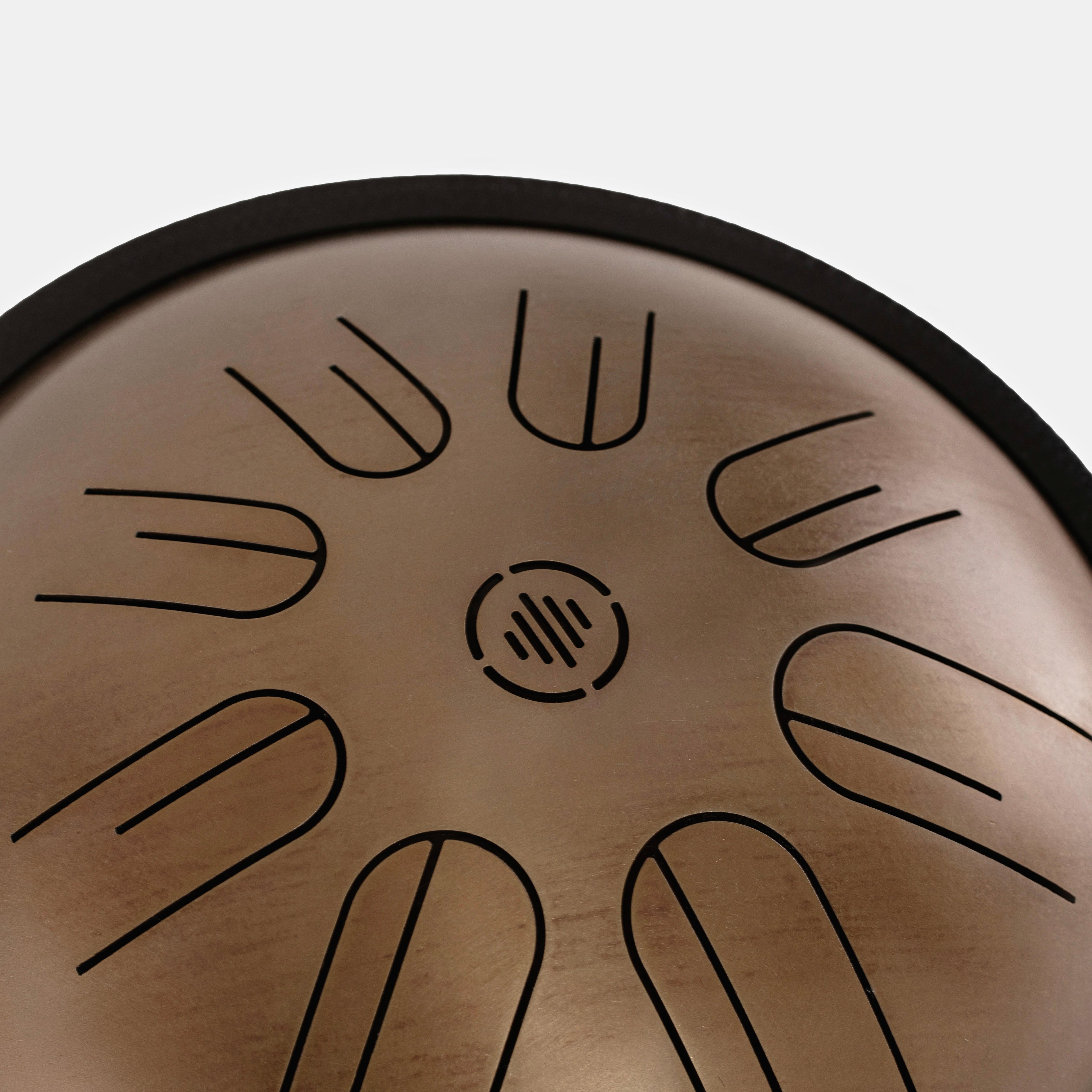 Close-up front view of Novadrum 28 steel tongue drum in stainless steel, highlighting precision-cut tongues and centered logo.