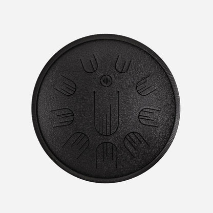 Front view of Novadrum 38 steel tongue drum in black textured finish, with precision-cut tongues arranged symmetrically around a central logo.