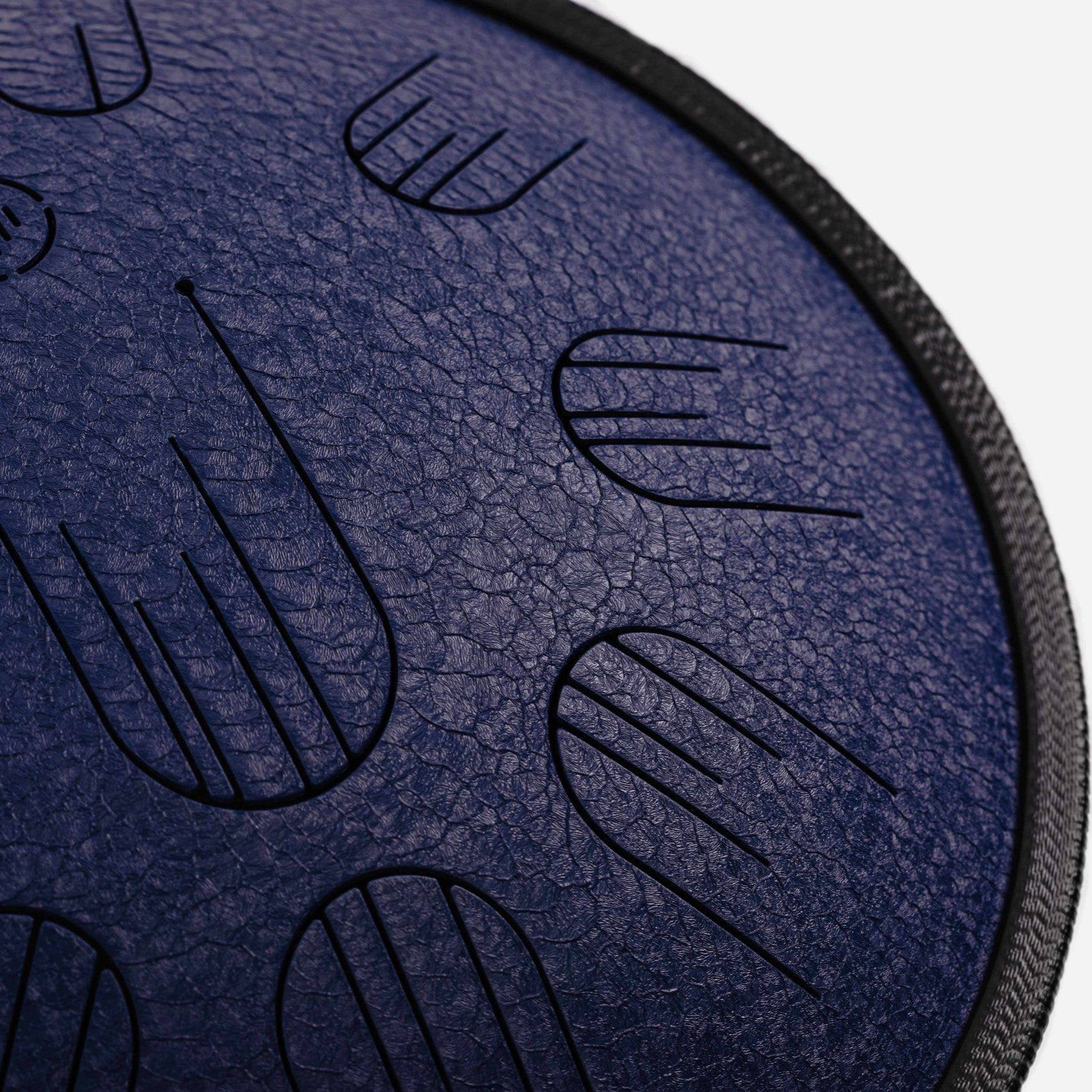 Close-up front view of Novadrum 38 steel tongue drum in blue textured finish, highlighting precision-cut tongues and centered logo.