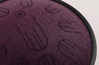 Close-up front view of Novadrum 38 steel tongue drum in black textured finish, highlighting precision-cut tongues and centered logo.