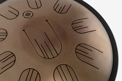 Close-up front view of Novadrum 38 steel tongue drum in stainless steel, highlighting precision-cut tongues and centered logo.