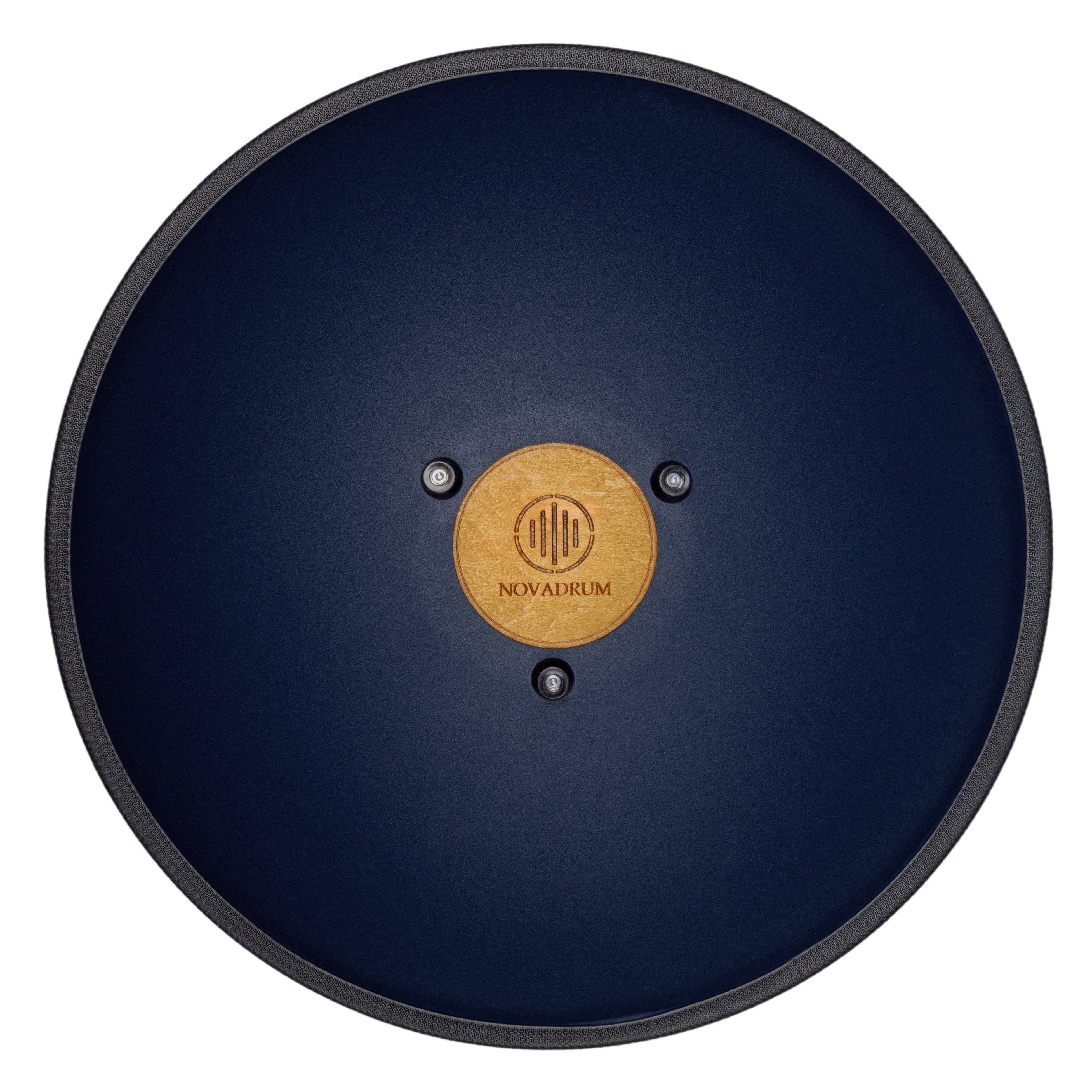 Back view of Novadrum 48 big steel tongue drum in blue matte, showing a wooden cover with engraved ‘NovaDrum’ branding, rubber feet, and black rope rim.