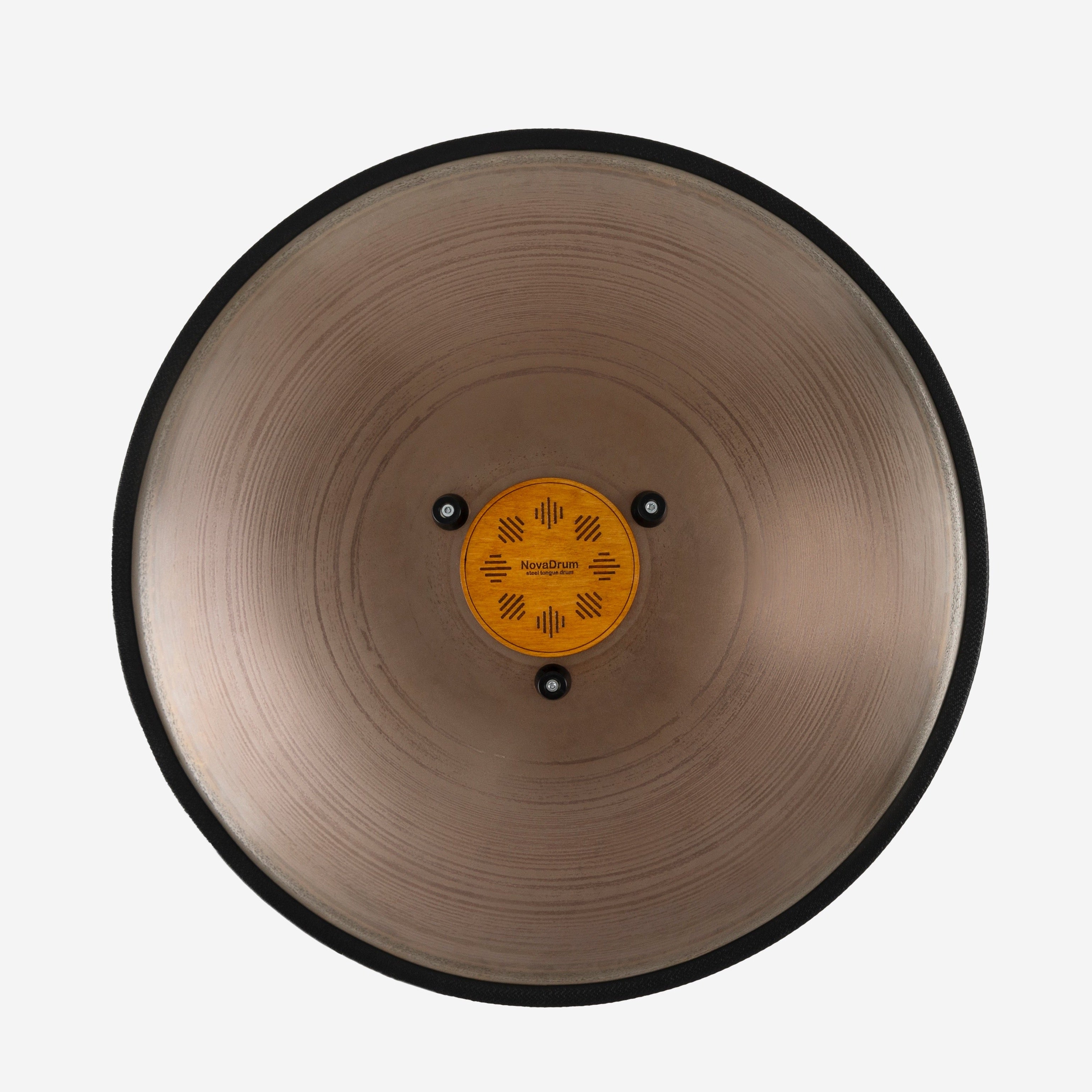 Back view of Novadrum 48 big steel tongue drum in stainless steel, showing a wooden cover with engraved ‘NovaDrum’ branding, rubber feet, and black rope rim.