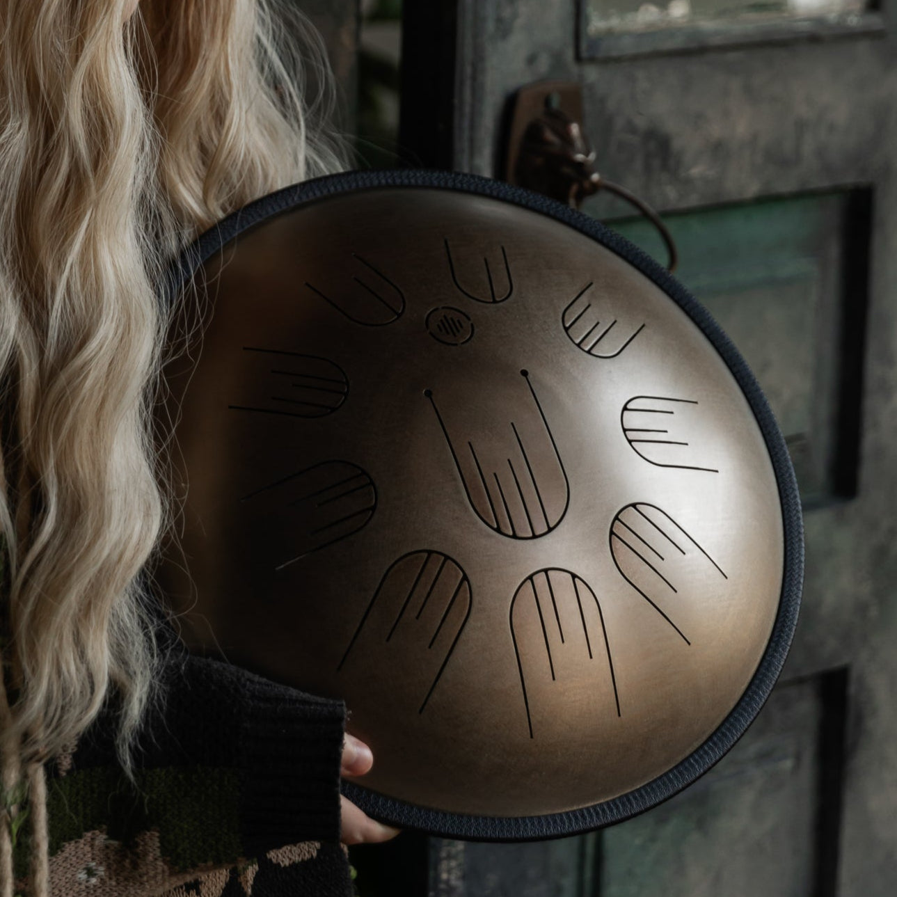 Person playing the Novadrum 38 steel tongue drum (also known as handpan)