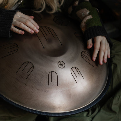 Person playing the Novadrum48 big steel tongue drum (also known as handpan)